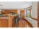 Kitchen with breakfast bar, granite countertops, wood cabinets, and a bay window at 961 Jimson Se Dr, Conyers, GA 30013