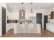 Modern kitchen with white cabinets, island, and stainless steel appliances at 945 Willingham Dr # 3, Hapeville, GA 30354
