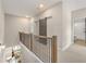 Upper hallway with sliding barn door and metal railing overlooking living area at 945 Willingham Dr # 3, Hapeville, GA 30354