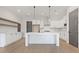 Modern kitchen with white cabinets, island, and wood floors at 945 Willingham Dr # 3, Hapeville, GA 30354