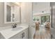 Clean bathroom with white vanity, quartz countertop, and large mirror at 945 Willingham Dr # 3, Hapeville, GA 30354