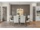 Elegant dining room with a large table, six chairs, and modern chandelier at 945 Willingham Dr # 3, Hapeville, GA 30354