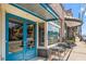 Drip Coffee shop exterior, blue doors and sidewalk seating at 945 Willingham Dr # 3, Hapeville, GA 30354