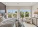 Spacious bedroom with large windows, plush bedding, and a sitting area at 945 Willingham Dr # 3, Hapeville, GA 30354