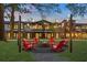 Outdoor fire pit surrounded by red Adirondack chairs at 945 Willingham Dr # 3, Hapeville, GA 30354