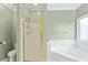 Bathroom features a shower, jetted tub, and updated fixtures at 140 Wisteria Blvd, Covington, GA 30016