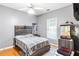 Bright bedroom with wood flooring, a double bed, and a fish tank at 140 Wisteria Blvd, Covington, GA 30016