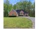 Brick house with a large front yard and driveway at 140 Wisteria Blvd, Covington, GA 30016