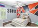 Bedroom with unique geometric wall art and hardwood floors at 140 Wisteria Blvd, Covington, GA 30016