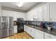 Modern kitchen with stainless steel appliances and white cabinets at 140 Wisteria Blvd, Covington, GA 30016
