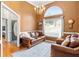 Spacious living room with leather furniture and an arched window at 140 Wisteria Blvd, Covington, GA 30016