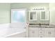 Spa-like bathroom with a corner soaking tub and double vanity at 140 Wisteria Blvd, Covington, GA 30016