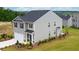 Two-story house with gray siding, dark roof, and a two-car garage at 12000 Conrad, Hampton, GA 30228