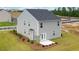 Rear view of a two-story house with gray siding, dark roof, and a patio at 12000 Conrad, Hampton, GA 30228