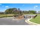 Gated community entrance with landscaping and a paved road at 12000 Conrad, Hampton, GA 30228