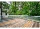 Wooden deck with white railing overlooking wooded area at 153 Hood Cir, Decatur, GA 30030