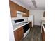 Kitchen with wood cabinets, white appliances, and vinyl flooring at 2794 Norfair Loop, Lithonia, GA 30038