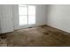 Simple carpeted bedroom with a window and white walls at 2794 Norfair Loop, Lithonia, GA 30038