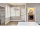 Bright dining area with a chandelier and view into a small bathroom at 79 Hammock Pl, Atlanta, GA 30312