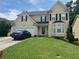 Two-story house with double garage and manicured lawn at 1080 Meadow Walk Ave, Lawrenceville, GA 30044