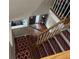 View of a wooden staircase with red runner rugs at 1080 Meadow Walk Ave, Lawrenceville, GA 30044