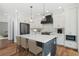 Bright kitchen featuring white cabinets, a large island, and hardwood floors at 100 Cottage Gate Ln, Roswell, GA 30076