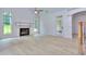 Light-filled living room featuring hardwood floors, fireplace, and French doors at 2006 Fontainbleau Dr, Conyers, GA 30094