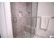 Walk-in shower with gray tile and a built-in seat at 1103 Highland Bluff Se Dr # 103, Atlanta, GA 30339