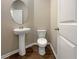 Small powder room with pedestal sink and toilet at 6246 Rockaway Rd, Atlanta, GA 30349