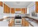 Kitchen with wood cabinets, stainless steel appliances, and granite countertops at 65 Hickory Cir, Carrollton, GA 30116