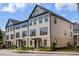 Three-story beige townhouse with gray accents at 3701 Allegretto Cir, Atlanta, GA 30339