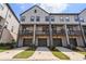 Three-unit townhome building with attached garages and private balconies at 3701 Allegretto Cir, Atlanta, GA 30339