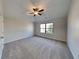 Large bedroom with ceiling fan and plush carpeting at 9378 Lantana Trl, Jonesboro, GA 30238