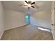 Bright bedroom featuring a ceiling fan and carpet at 9378 Lantana Trl, Jonesboro, GA 30238