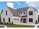 Stunning two-story home with brick facade and a three-car garage at 102 Cottage Gate Ln, Roswell, GA 30076