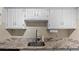 White kitchen cabinets and granite countertops at 6851 Roswell Rd # B8, Sandy Springs, GA 30328