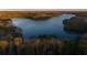 Stunning aerial view of a serene lake surrounded by lush trees at 3012 Sunset Pass, Canton, GA 30114