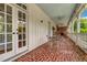 Covered porch with brick flooring and French doors at 161 Blair Valley Ne Dr, Marietta, GA 30060