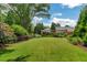 Expansive backyard showcasing a lush lawn and distant view of the home and pool at 161 Blair Valley Ne Dr, Marietta, GA 30060