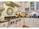 Modern gas cooktop and stainless steel range hood in white kitchen at 161 Blair Valley Ne Dr, Marietta, GA 30060