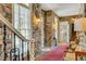 Elegant entryway with stone walls, hardwood floors, and a staircase at 161 Blair Valley Ne Dr, Marietta, GA 30060