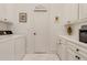 Laundry room with white cabinets, marble floors, and built-in storage at 161 Blair Valley Ne Dr, Marietta, GA 30060