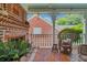 Cozy porch with brick flooring, wicker chairs, and fireplace at 161 Blair Valley Ne Dr, Marietta, GA 30060