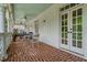 Spacious brick porch with ceiling fan and outdoor seating at 161 Blair Valley Ne Dr, Marietta, GA 30060