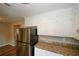 Kitchen with stainless steel refrigerator and granite countertops at 707 Arbor Hill Dr, Stone Mountain, GA 30088