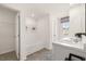 Double vanity bathroom with a soaking tub and grey tiled floors at 318 Elgin Dr, Lawrenceville, GA 30045