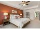 Main bedroom with carpeted floor, accent wall and ceiling fan at 318 Elgin Dr, Lawrenceville, GA 30045