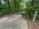Gated driveway leading to a wooded area at 1809 Silver Ridge Ct, Stone Mountain, GA 30087
