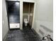 Modern bathroom with dark tile and updated toilet at 1809 Silver Ridge Ct, Stone Mountain, GA 30087