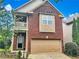 Two story brick home with attached garage and balcony at 1635 Yukon Ct, Atlanta, GA 30349